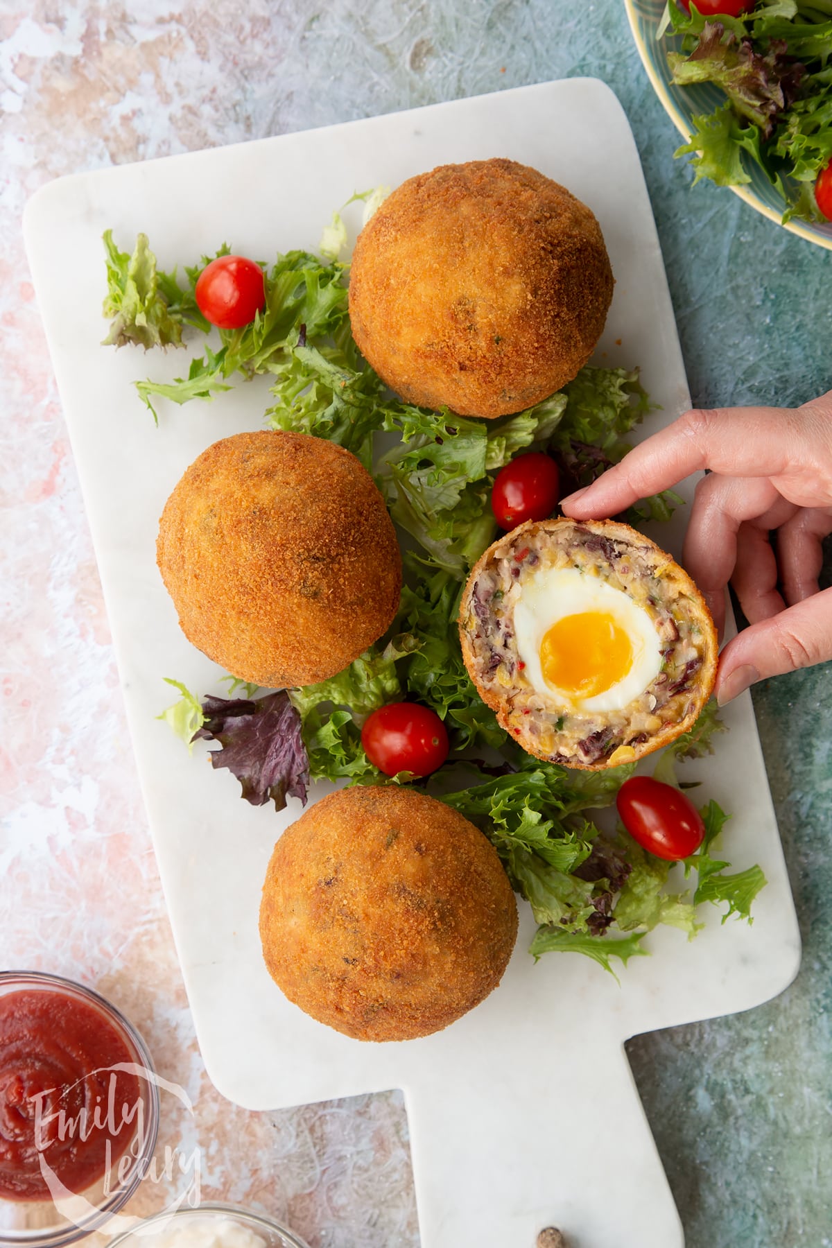 4 cooled scotch eggs cut in half over 3 other vegetarian scitch eggs