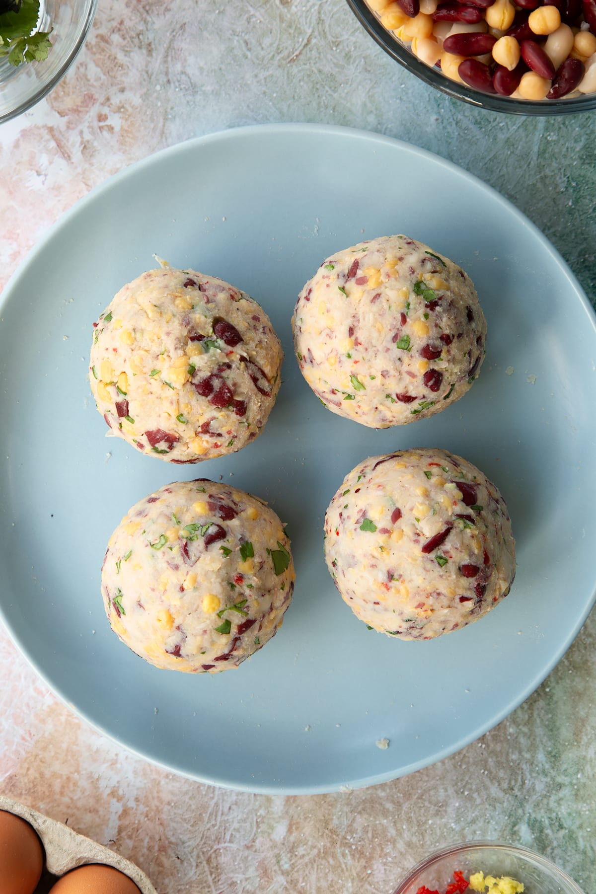 4 vegetarian stuffing ball rolled smoothly on a pale blue plate