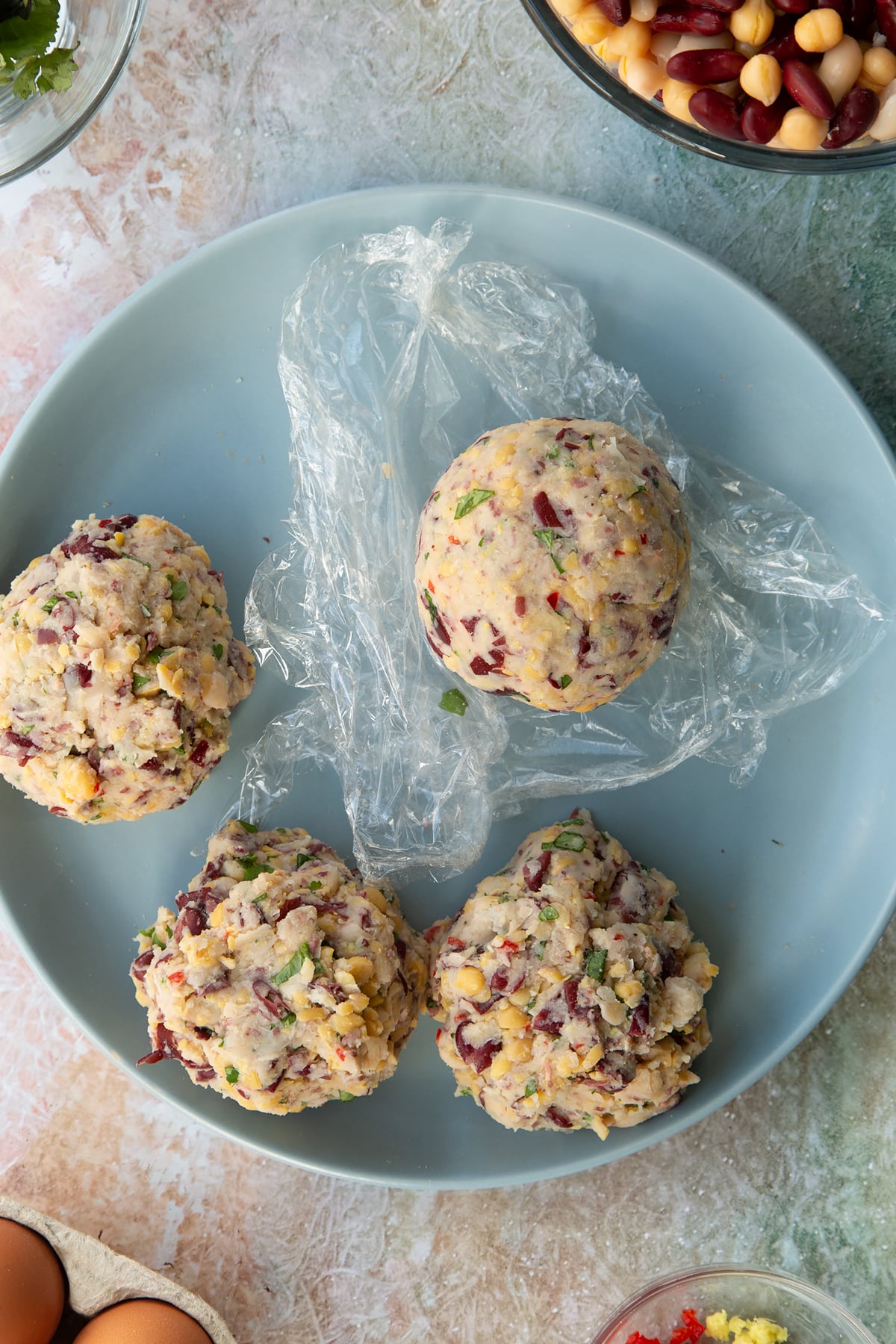 vegetarian stuffing ball rolled smoothly on a piece of cling film.