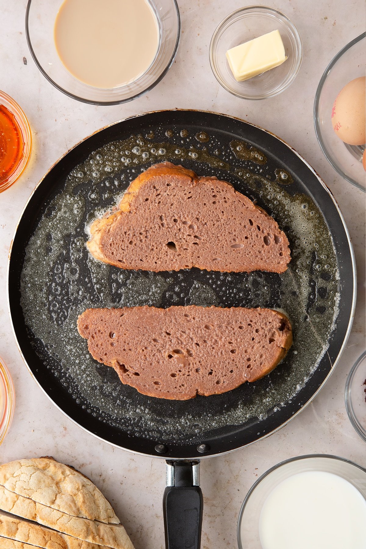 Overhead shot of the slices of bread laid ontop of the pan.