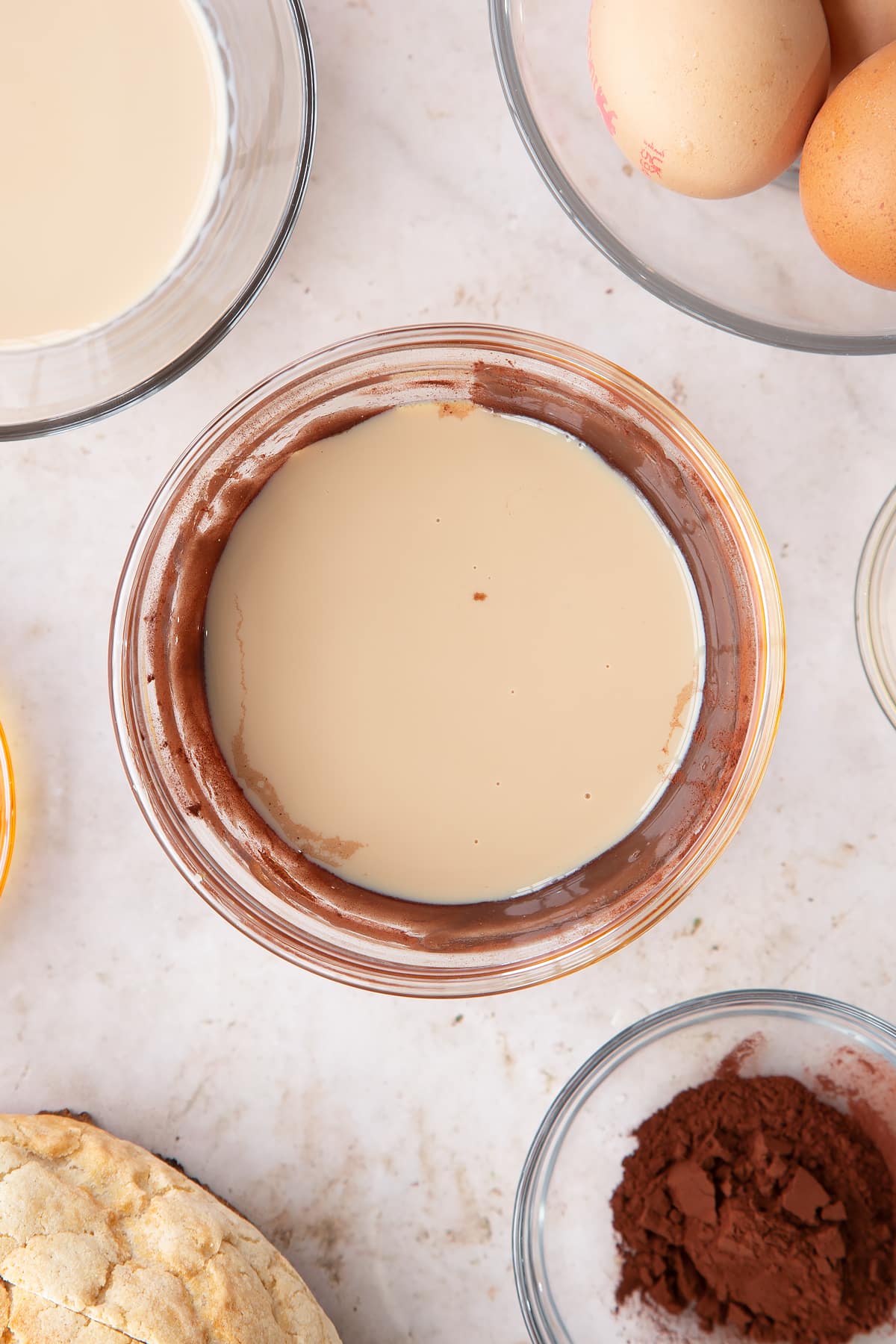 Overhead shot of the baileys being added to the mixing bowl of syrup ingredients.