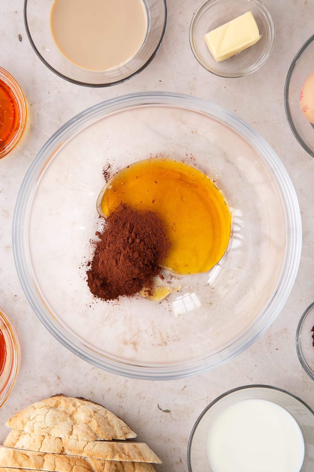 Overhead shot of cocoa and golden sryup in a mixing bowl.