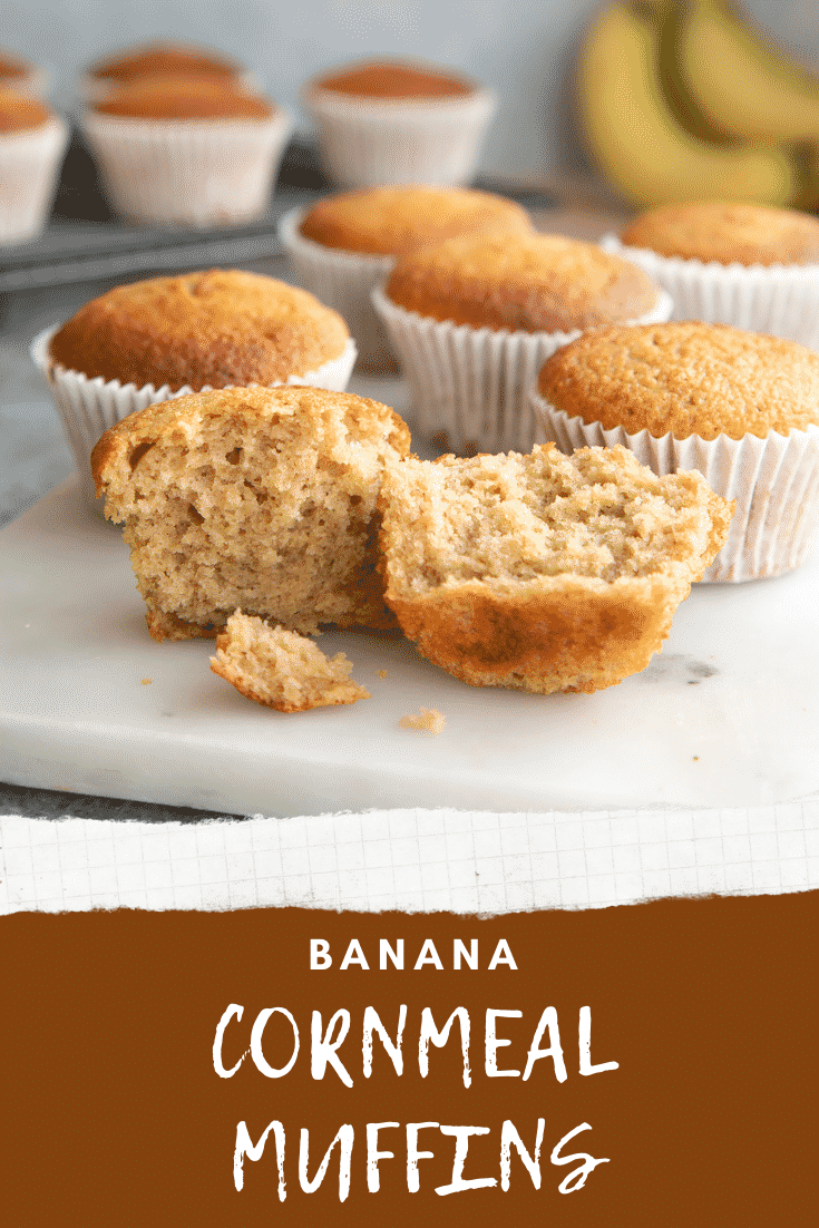 Banana cornmeal muffins on a white marble board. One has been broken open. Caption reads: banana cornmeal muffins. 