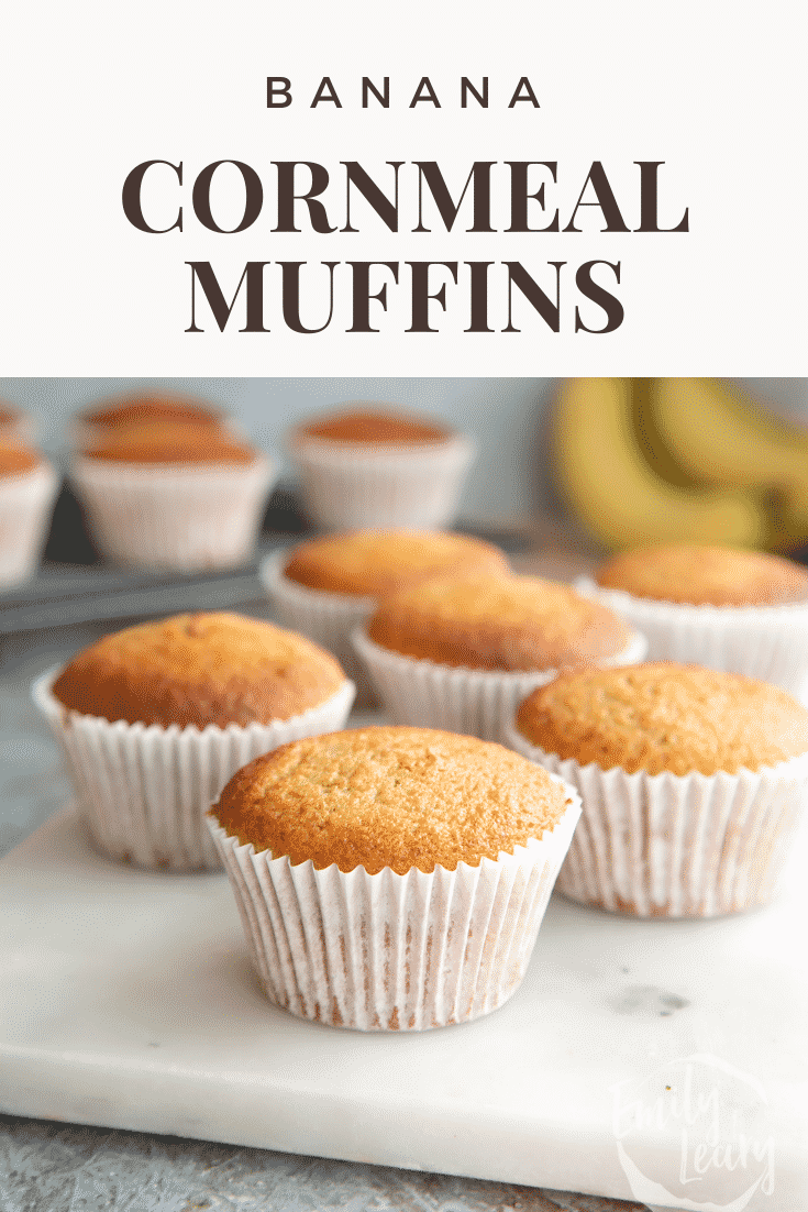 Banana cornmeal muffins on a white marble board. Caption reads: banana cornmeal muffins. 