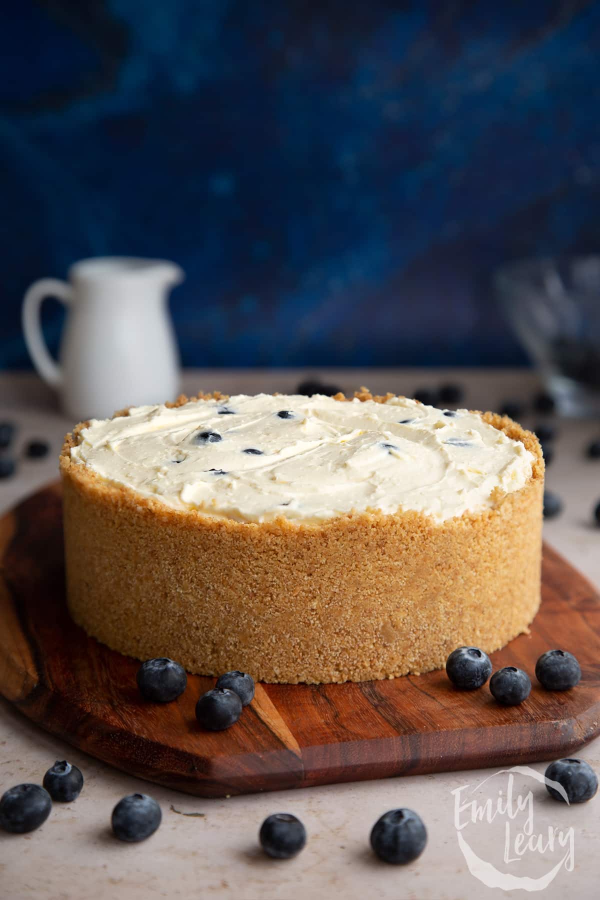 Blueberry cheesecake pie on a wooden board. 