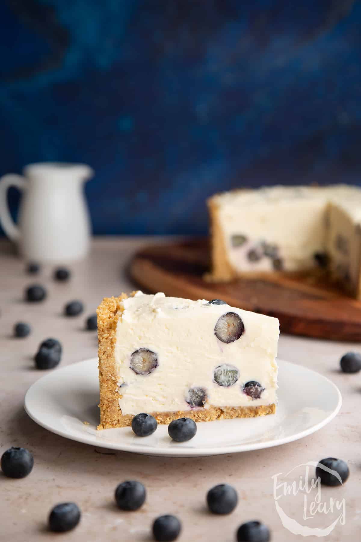 Slice of Blueberry cheesecake pie on a white plate.