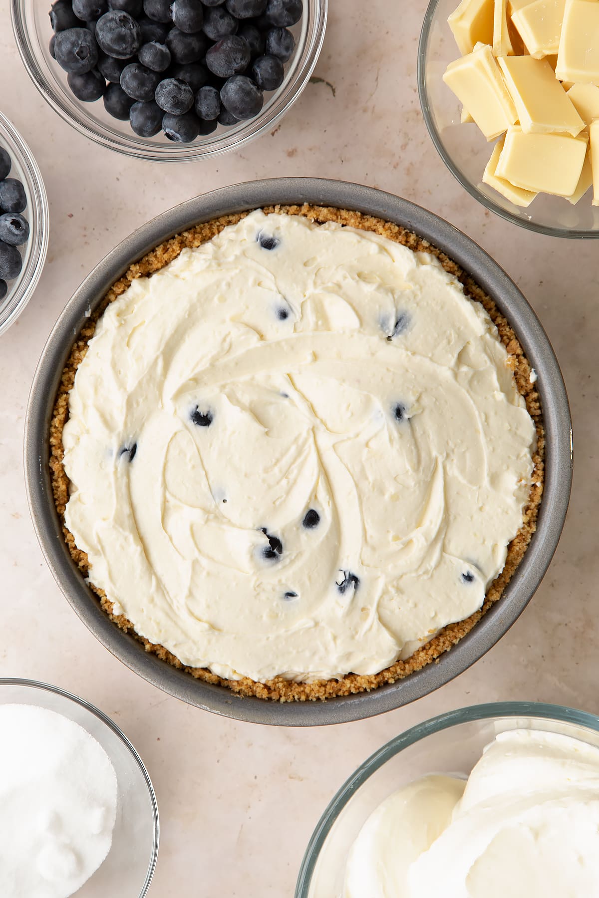 Blueberry cheesecake pie in a tin, shown from above.