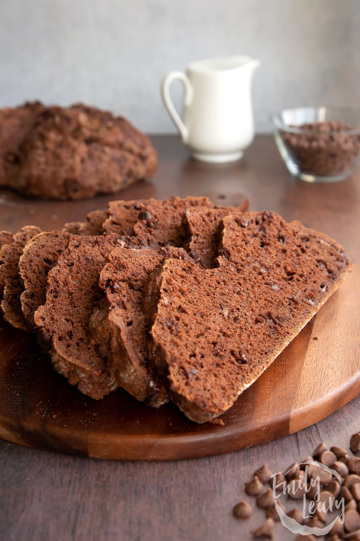 Close up shot of the sliced chocolate soda bread on a wooden board.