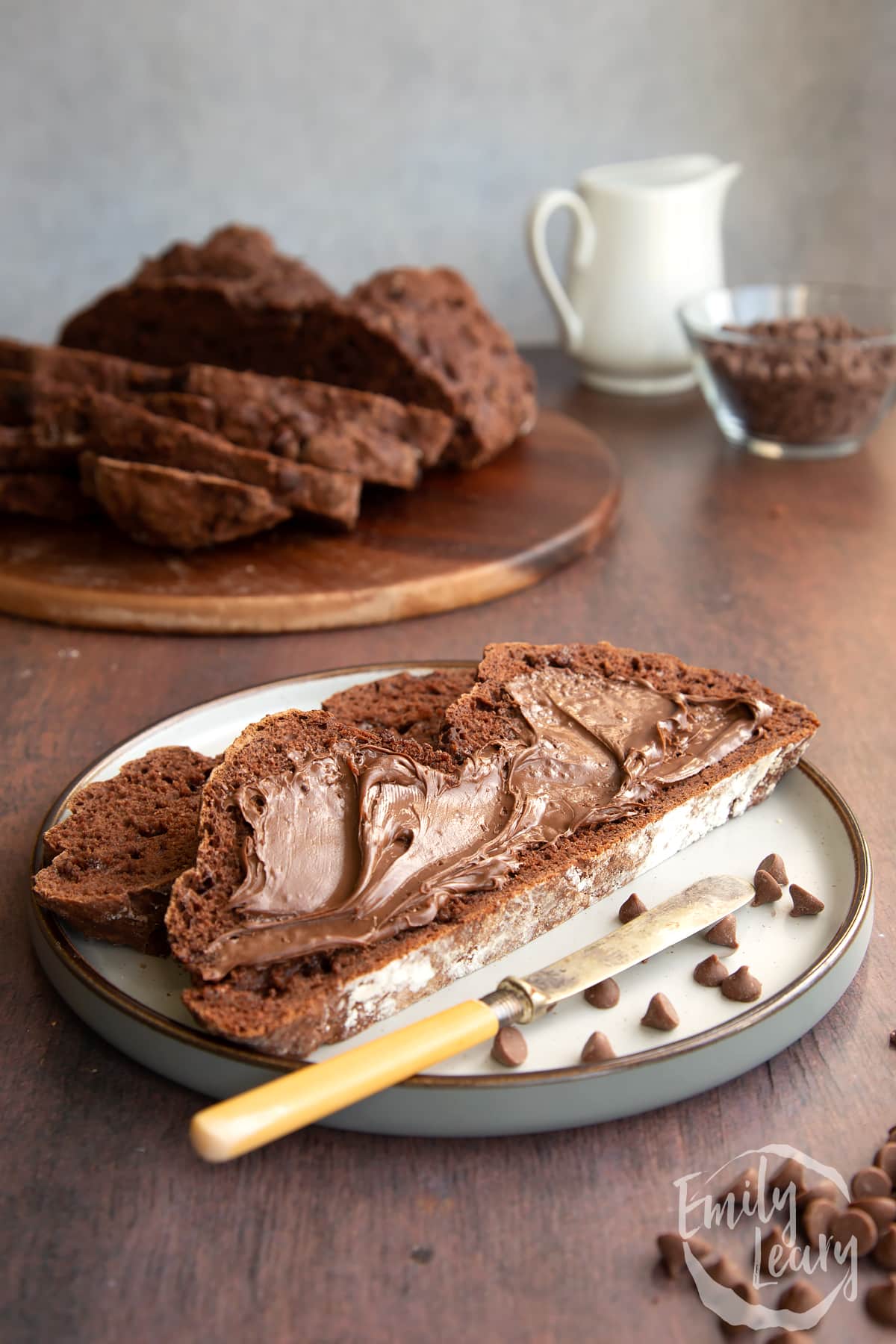 Close up shot of the sliced chocolate soda bread served on a decorative plate and topped with chocolate spread.