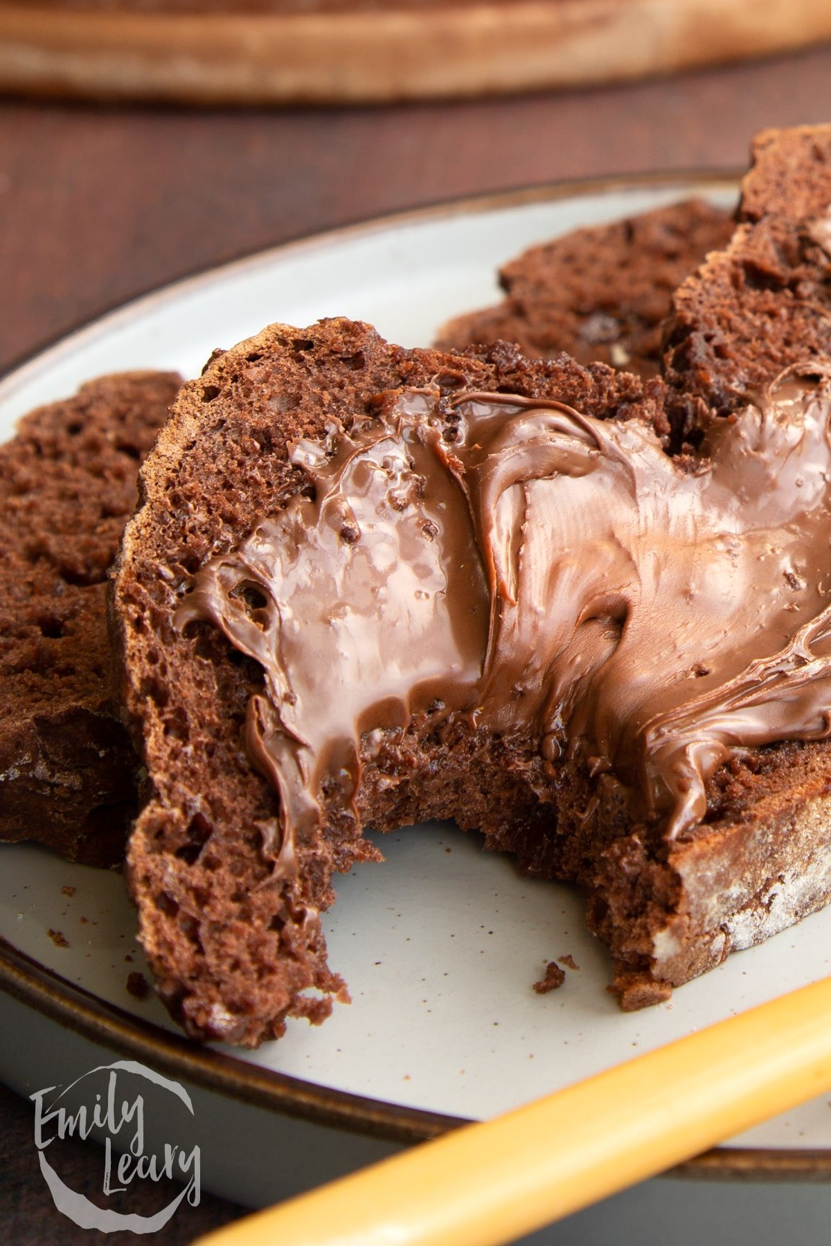 Close up shot of the chocolate soda bread having had a bite taken out of it.