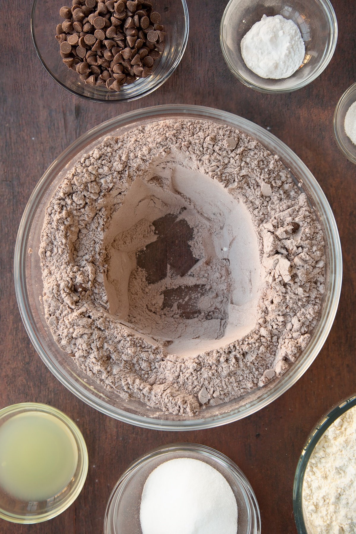 Overhead shot of the chocolate soda bread ingredients being added to a mixing bowl.
