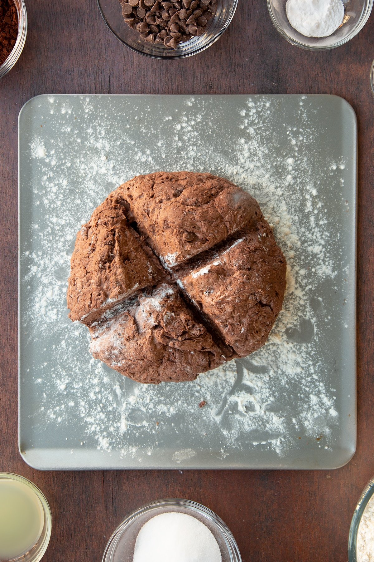 Overhead shot of the chocolate soda bread dough having a cross marked through it to help it rise.