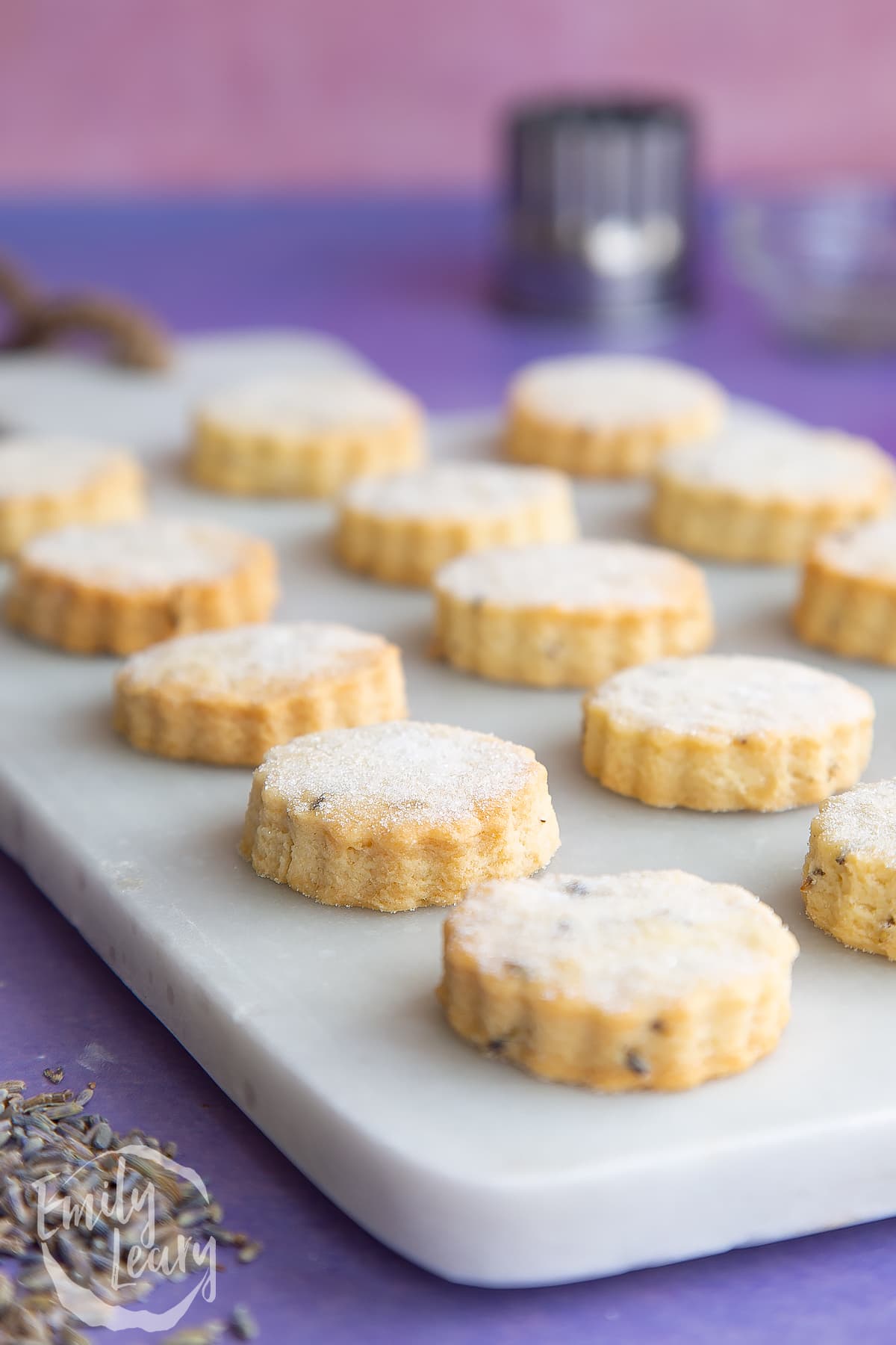 Lavender shortbread cookies on a marble board.