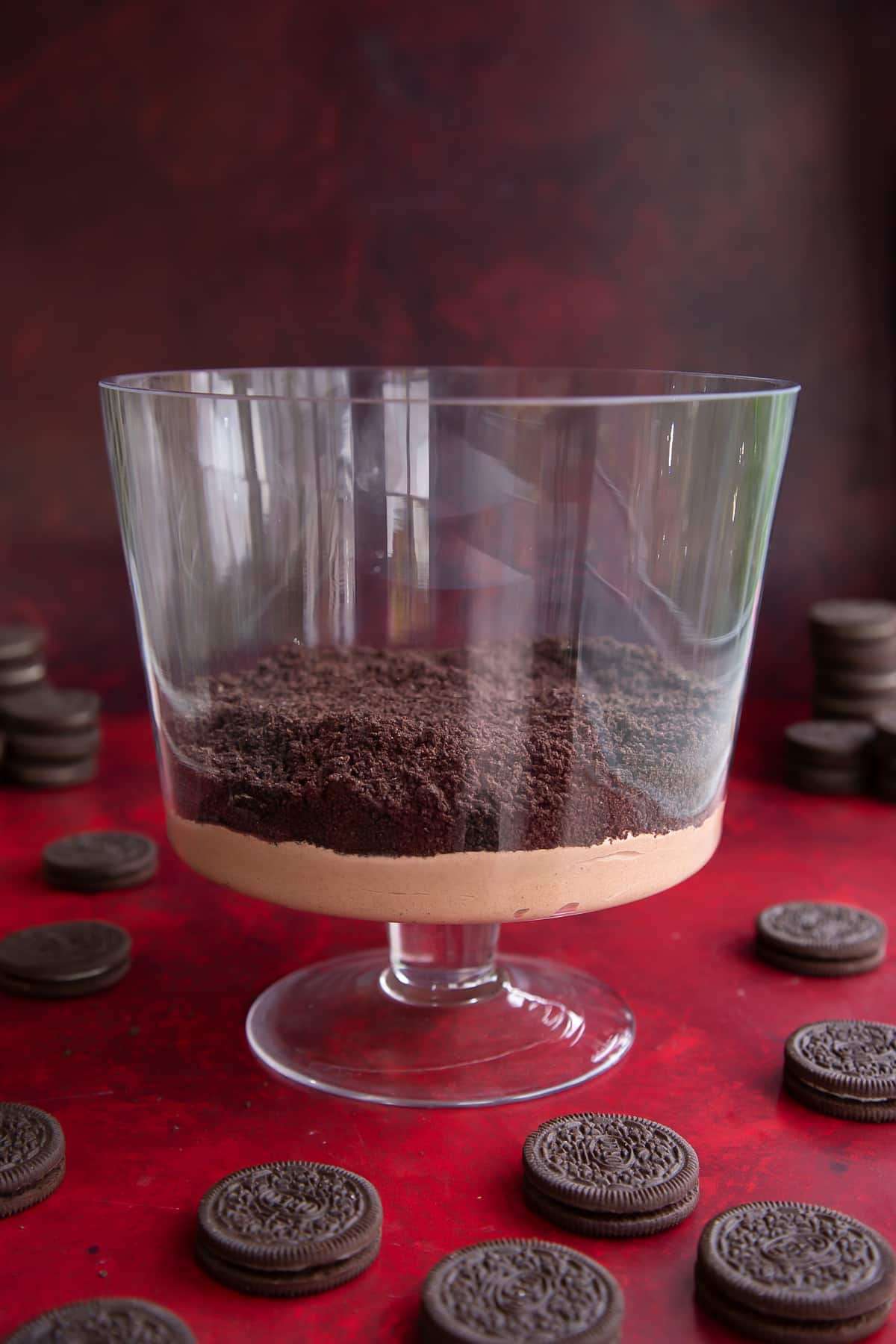 A layer of chocolate pudding, then crushed Oreos in a trifle bowl.