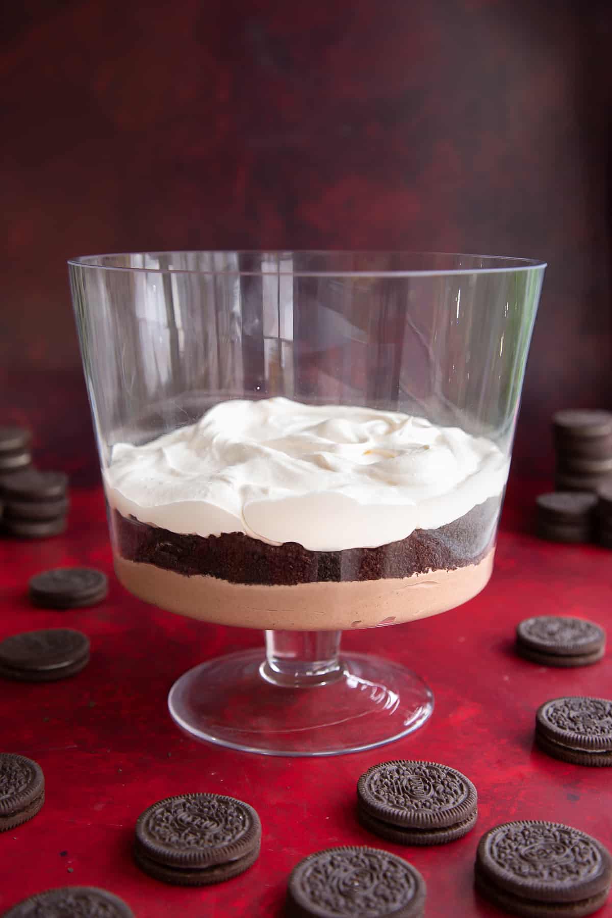 A layer of chocolate pudding, then crushed Oreos, then whipped cream in a trifle bowl.