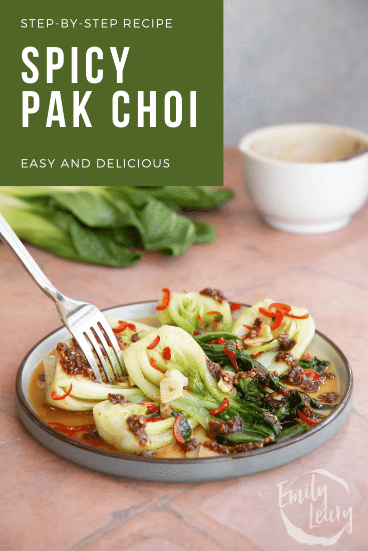 Spicy pak choi served on a plate with a fork coming in from the top with text at the top describing the image for Pinterest.