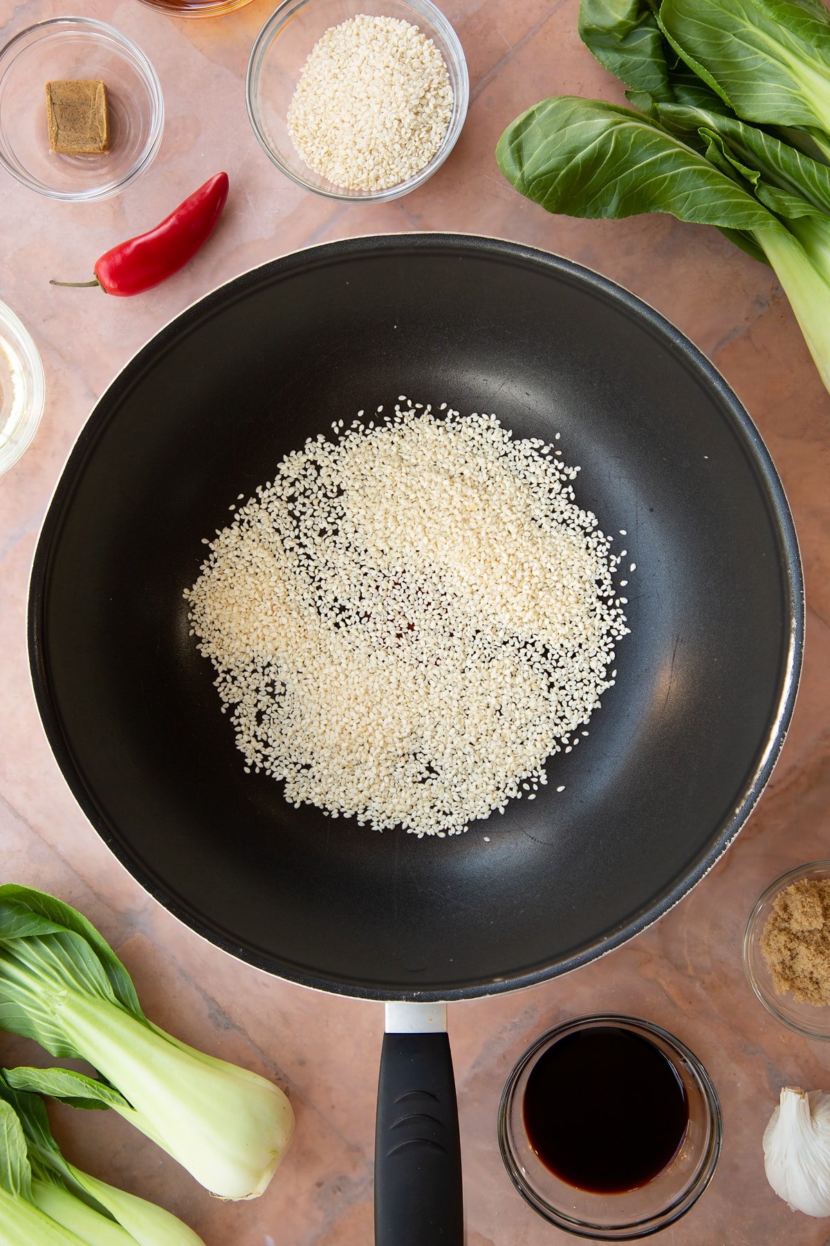 Overhead shot of seasme seeds in a pan.