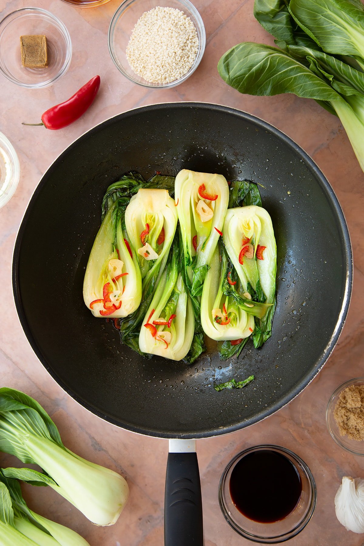 Overhead shot of the pak choi having been basted with the spicy ingredients. 