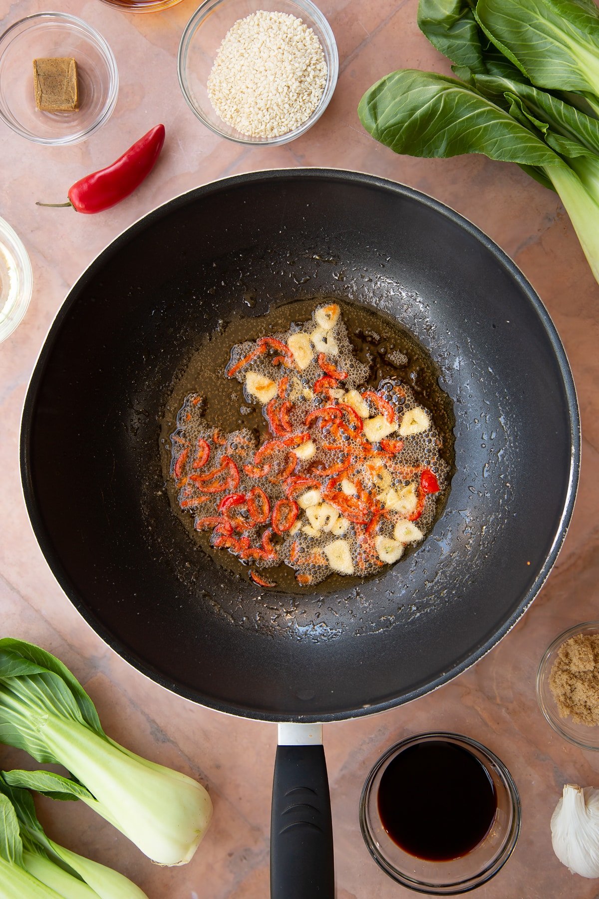 Overhead shot of some of the ingredients for the spicy pak choi recipe in a pan.