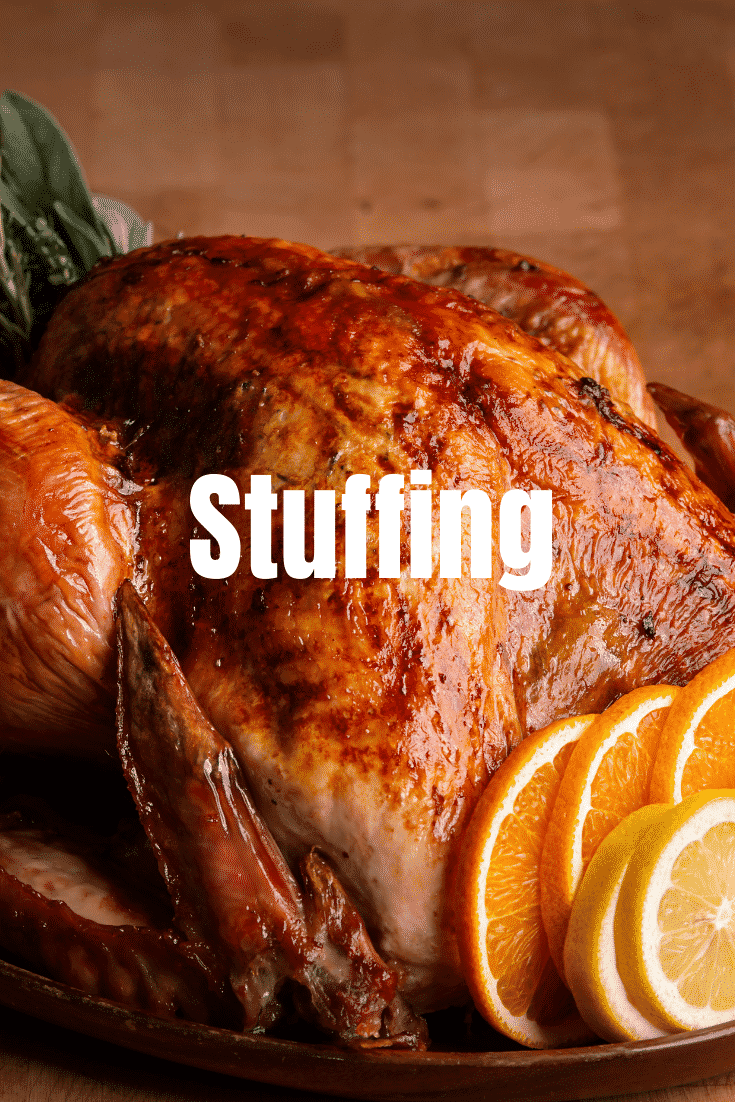 Close up shot of a cooked turkey with orange slices on the side and the text 'Stuffing' ontop.