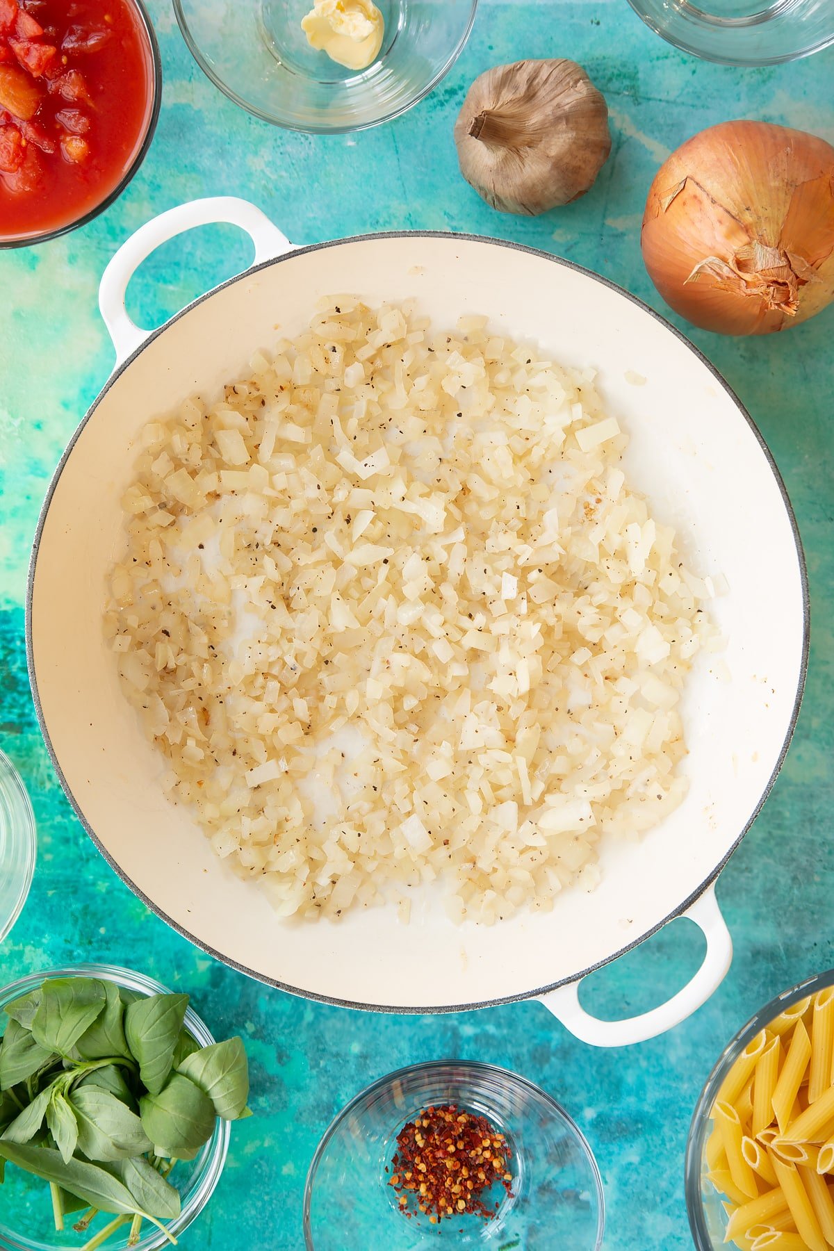 Overhead shot of diced onions in a pan having been simmered on a low heat.