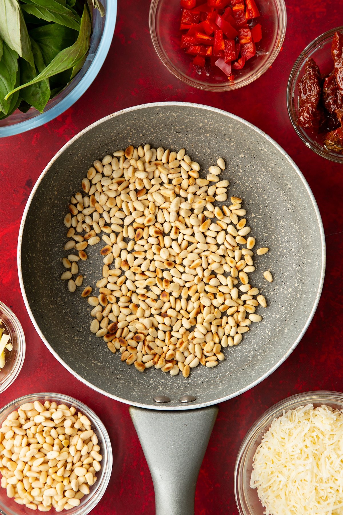 Overhead shot of the pine nuts having been on a low heat for a couple of minutes.