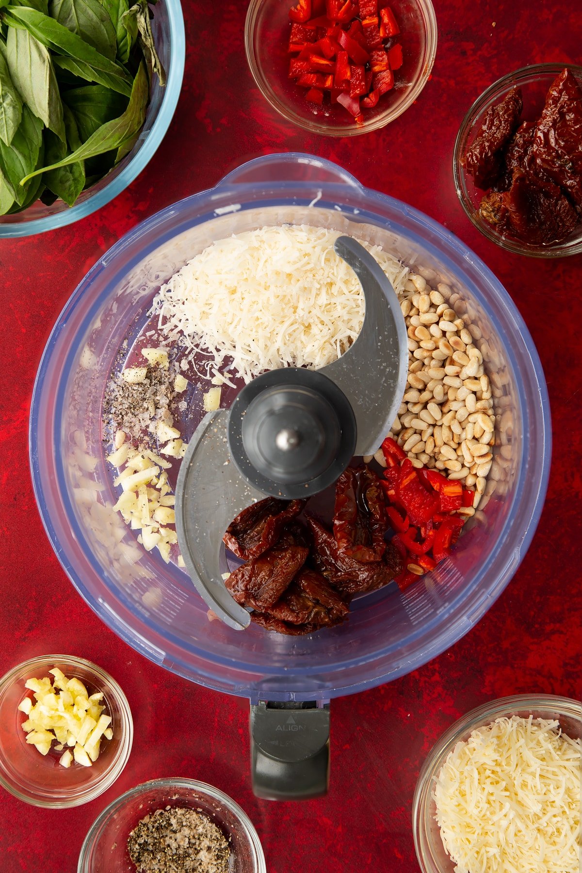 Overhead shot of some of the ingredients for the chilli pesto inside a blender.