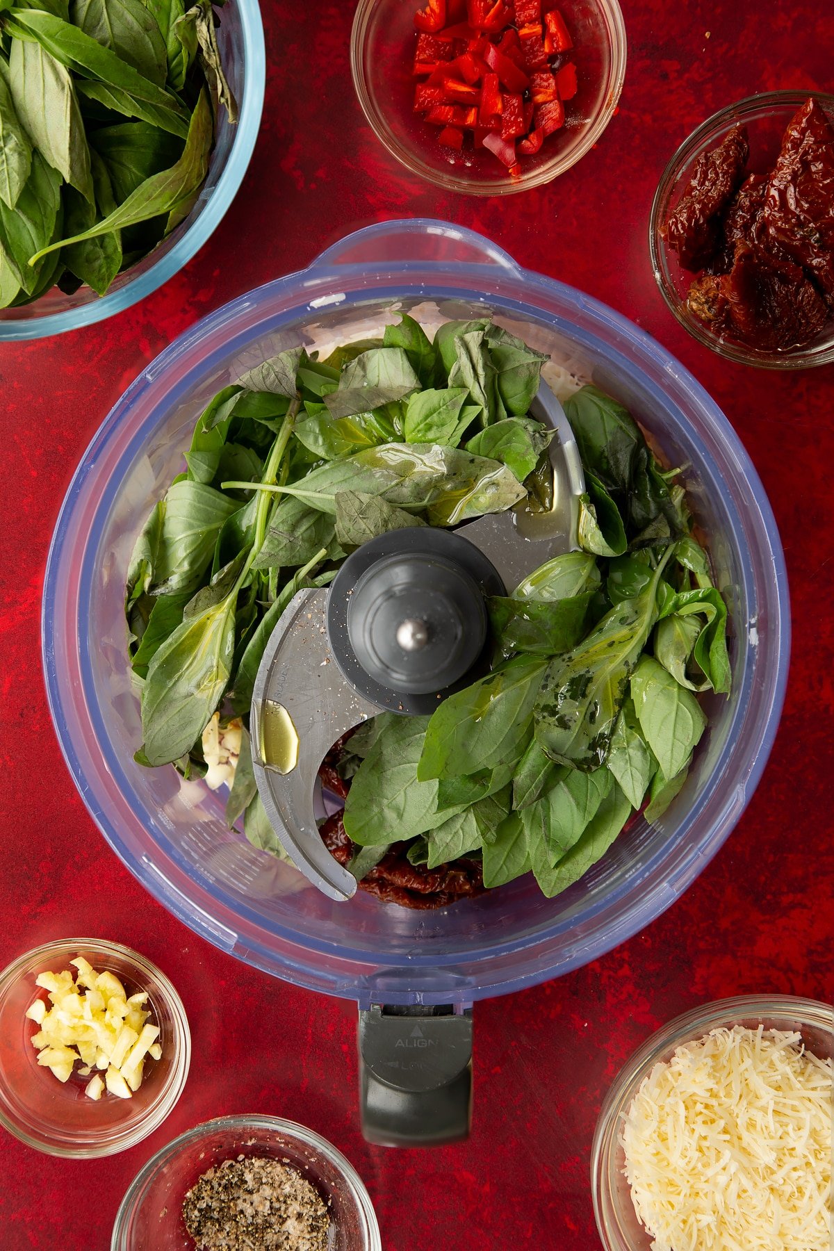 Overhead shot of some of the ingredients for the chilli pesto inside a blender.