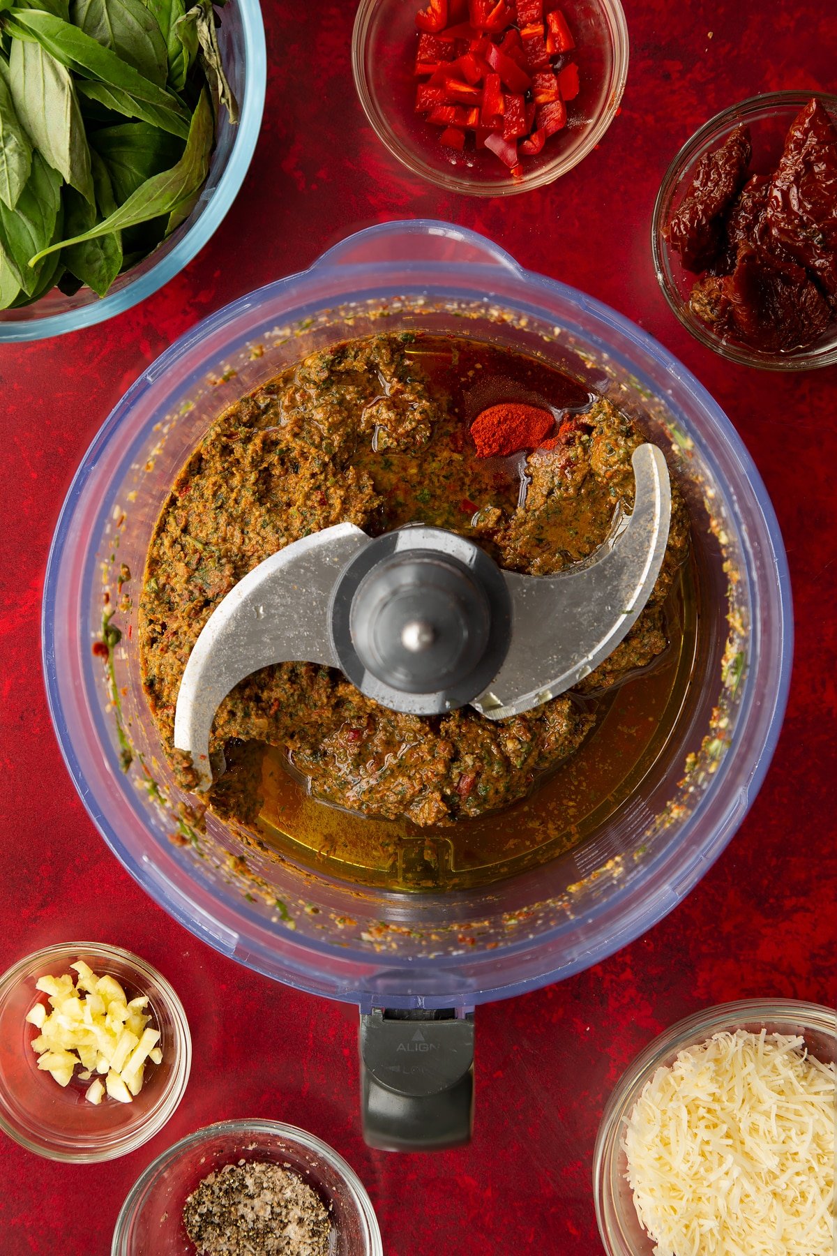 Overhead shot of the chilli pesto blended ingredients inside a blender.