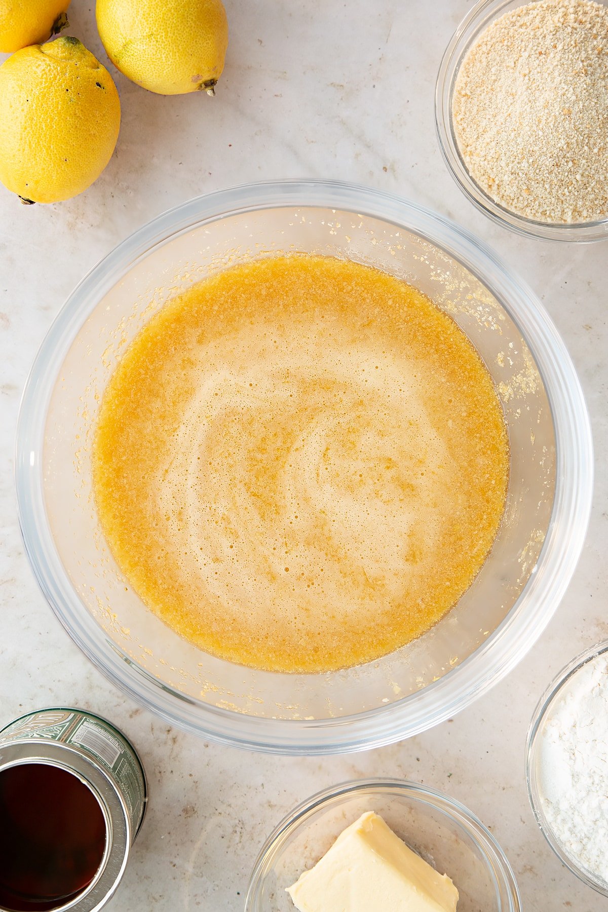 Overhead shot of the lemon treacle tart ingredients whisked together in a bowl.