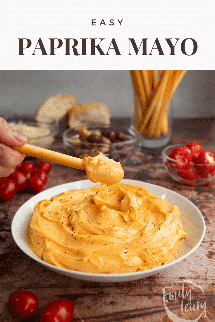Paprika mayo in a shallow white bowl.  A breadstick is being dipped in. Caption reads: Easy paprika mayo