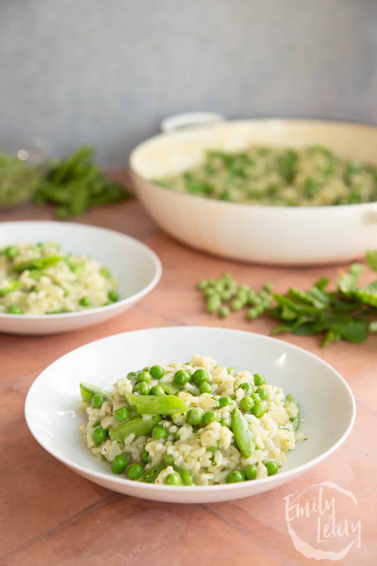 Side on shot of a plate of pea and mint risotto.