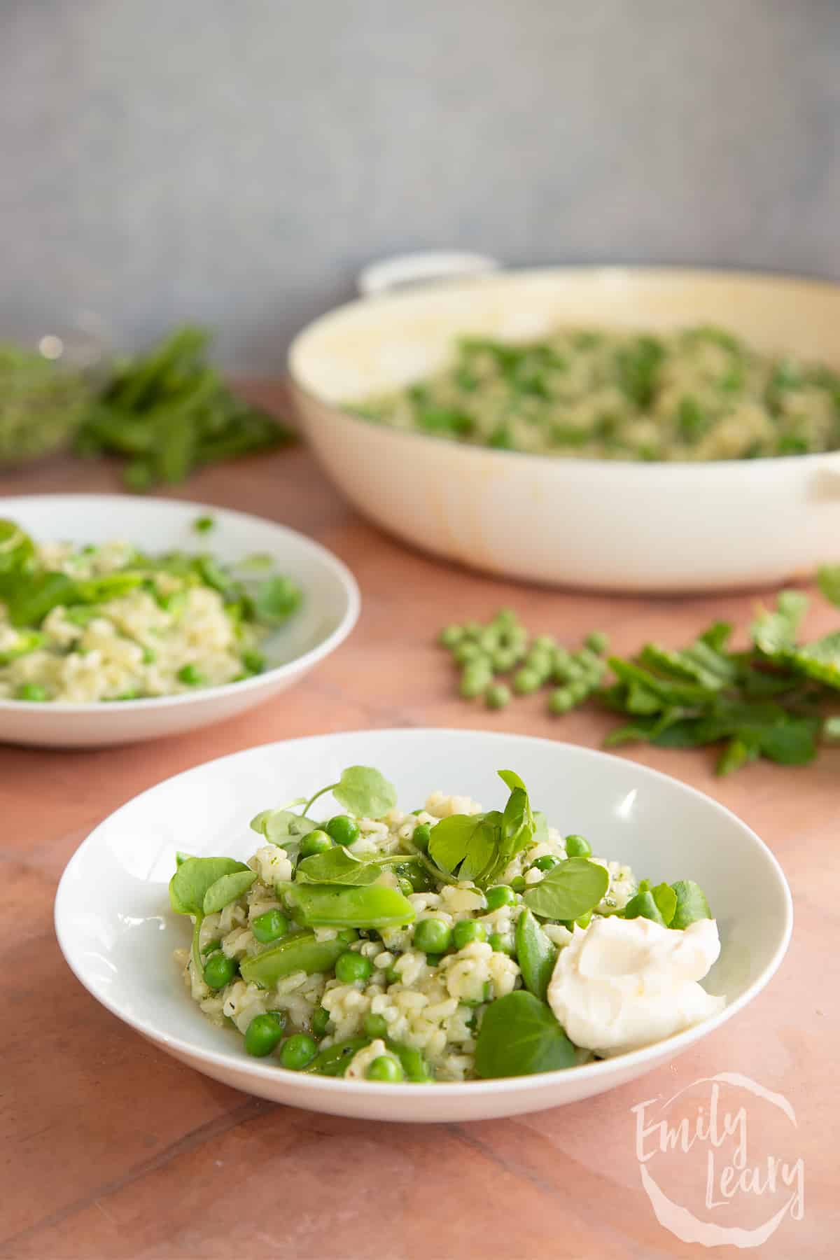 Side on shot of a bowl of pea and mint risotto.