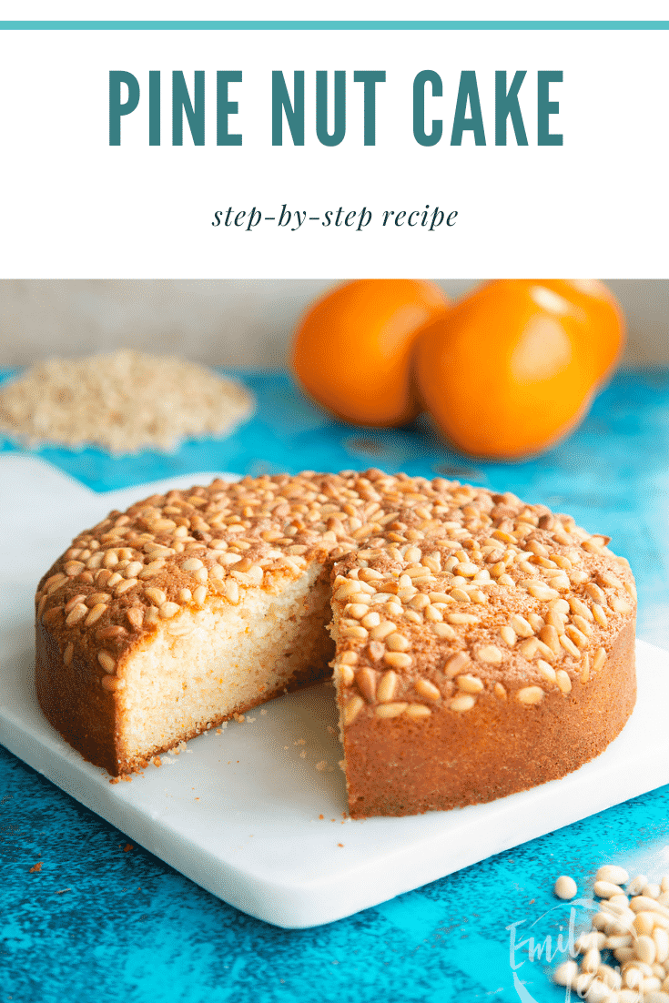 Pine nut cake on a white marble board with a slice taken. Caption reads: Pine nut cake step-by-step recipe.