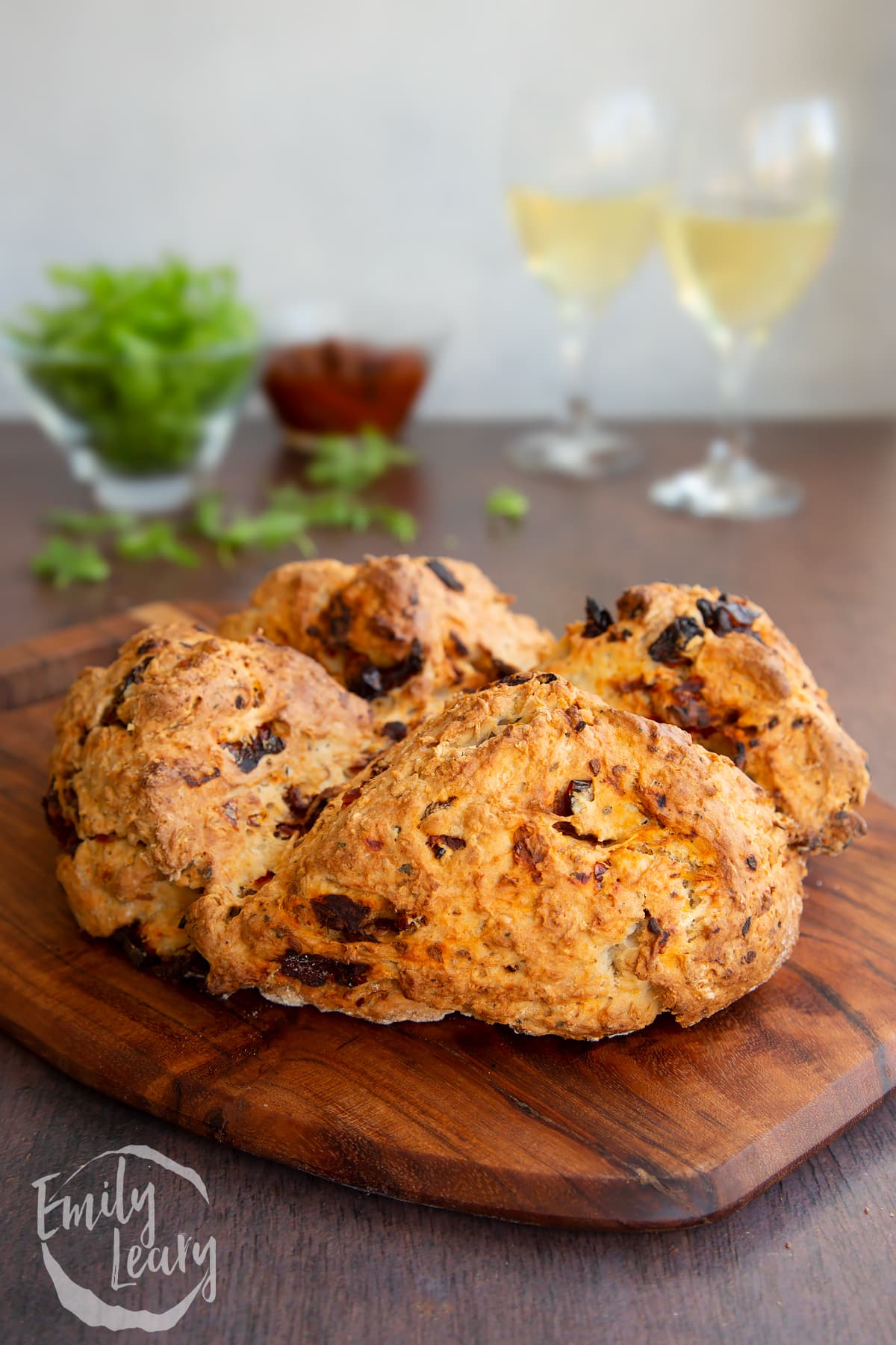 Sundried tomato soda bread loaf on a wooden board.