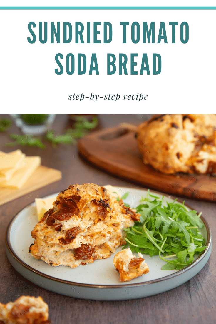 A piece of sundried tomato soda bread on a plate with salad. Caption reads: Sundried tomato soda bread step-by-step recipe