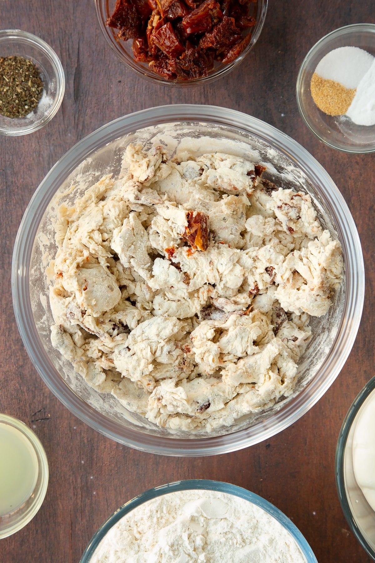 Sundried tomato soda bread dough in pieces in a bowl.