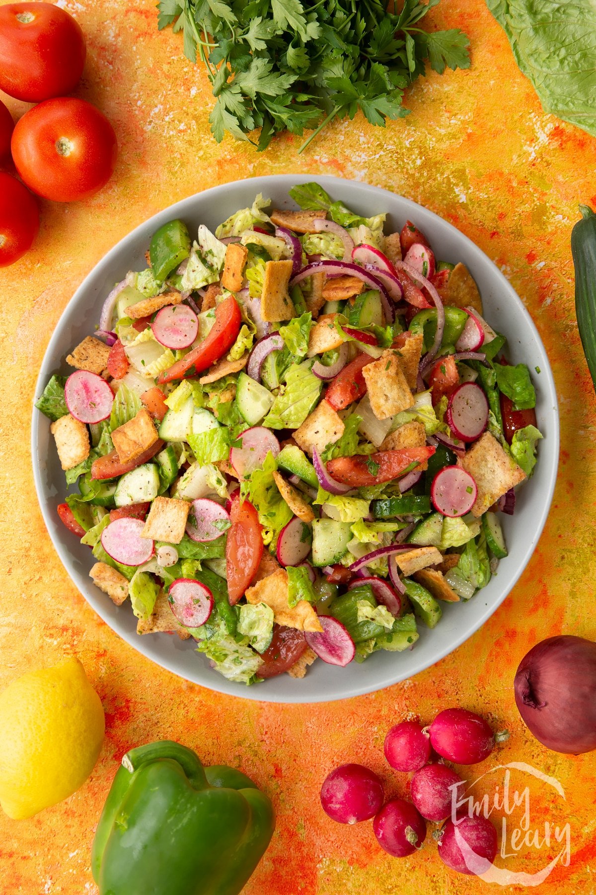 Vegan fattoush served on a large grey plate.