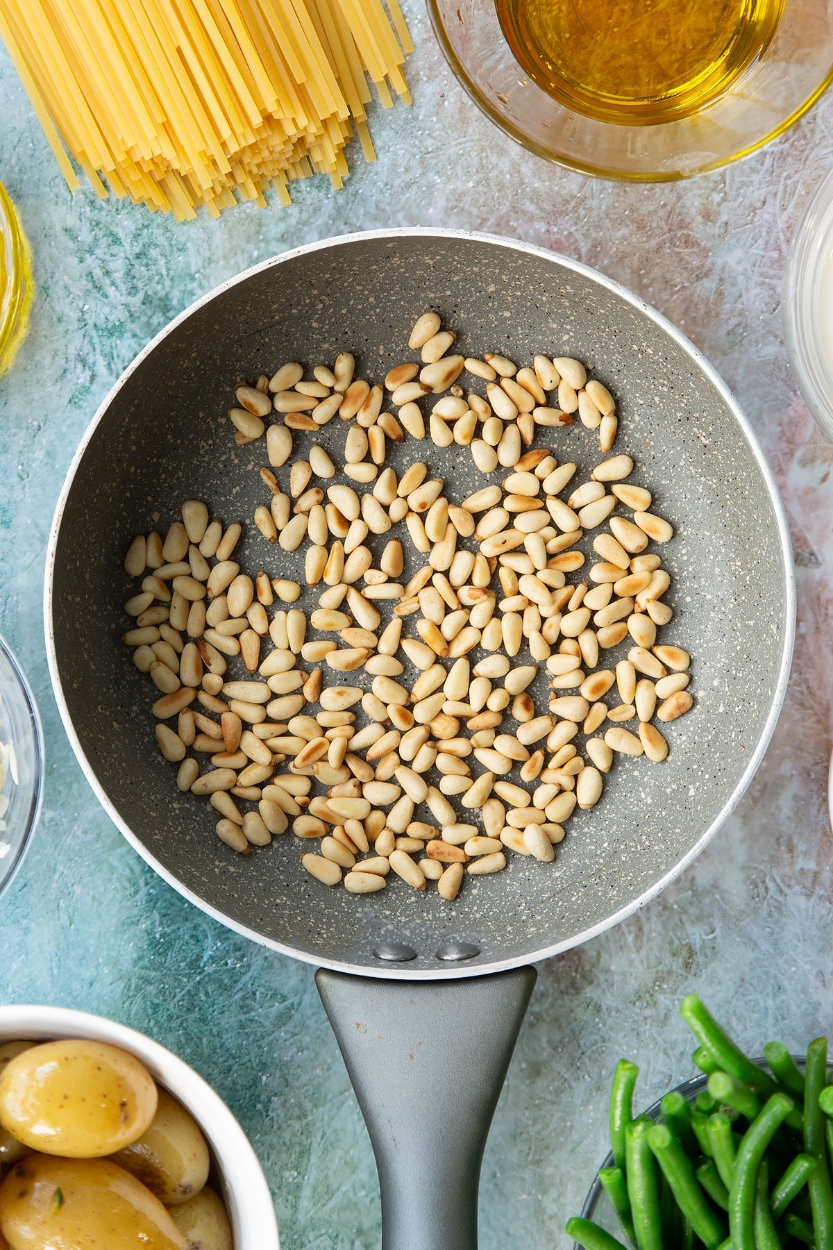 Overhead shot of the pine nuts having been toasted.