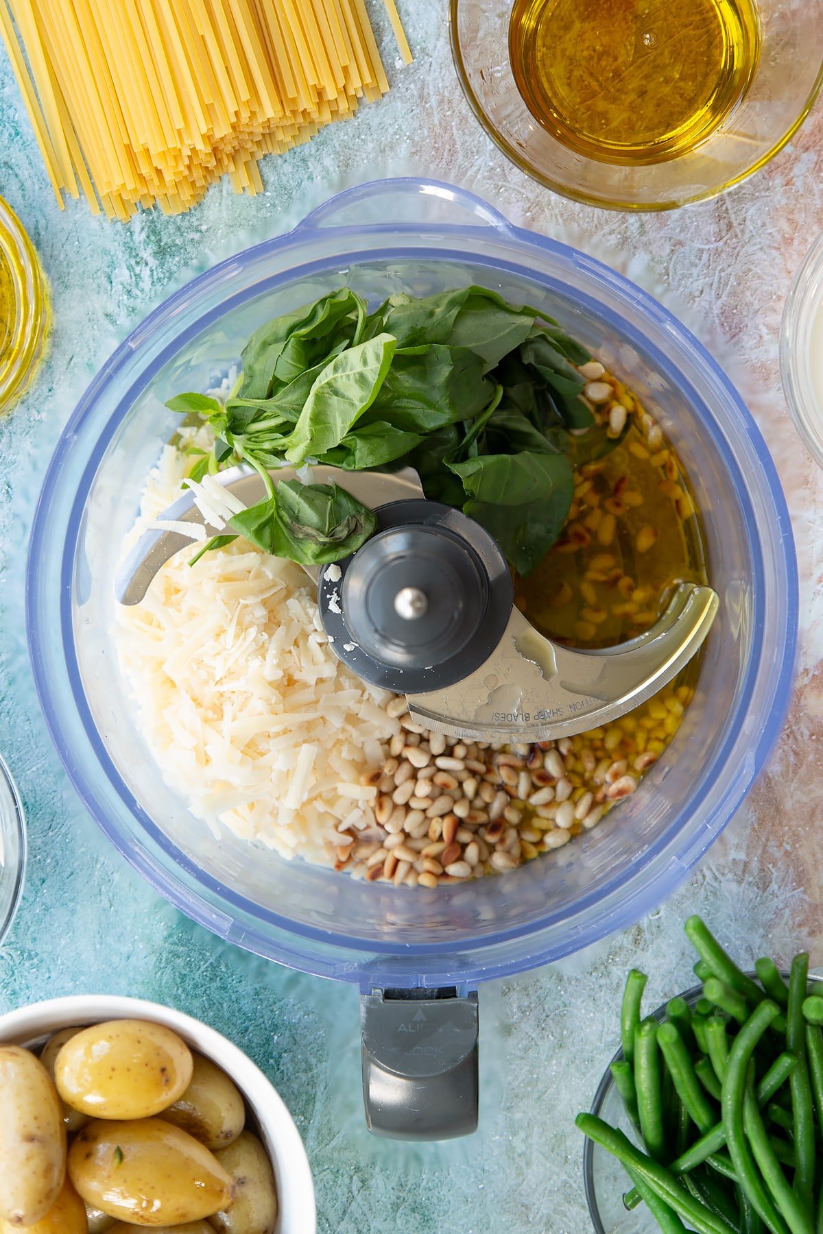 Overhead shot of the blinder with the ingredients for the pesto.