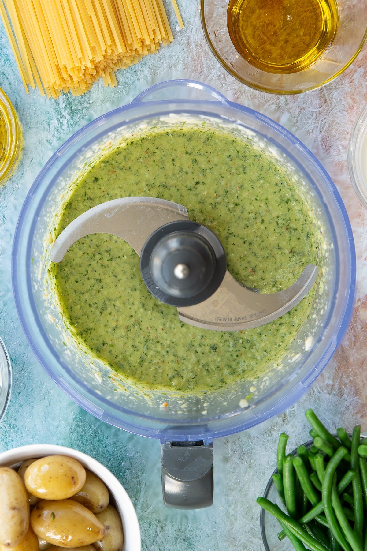 Overhead shot after the blender has been used to create the pesto from ingredients.