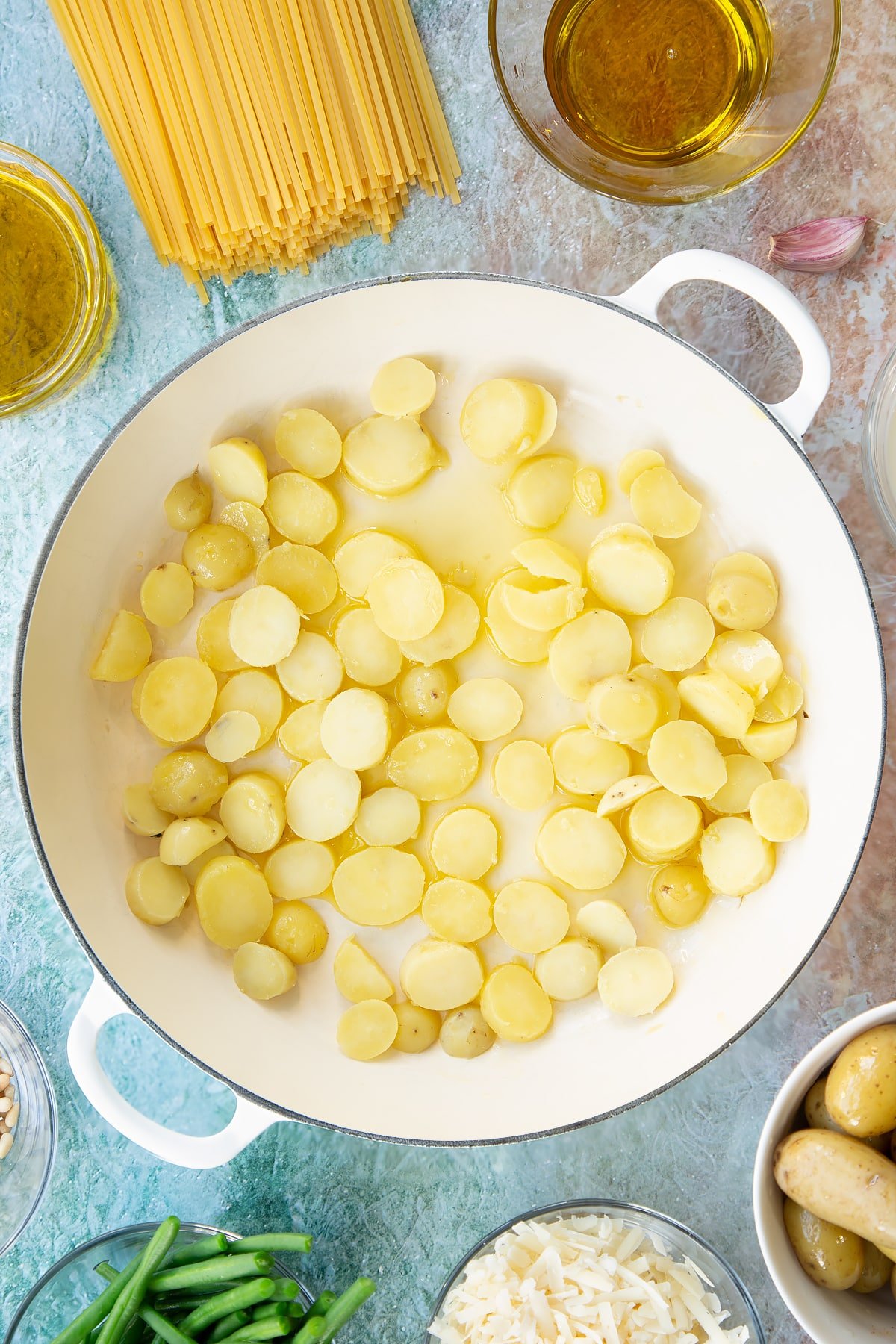 Overhead shot of the slices potatoes in a pan