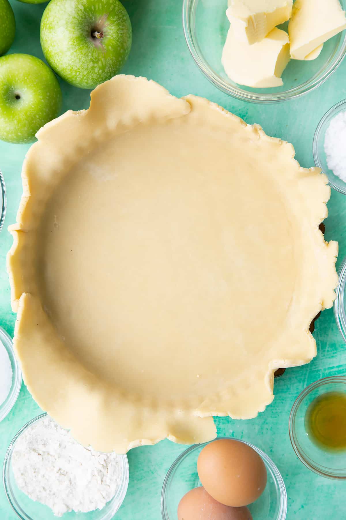 Lining the pastry tin with the finished rolled out pastry.