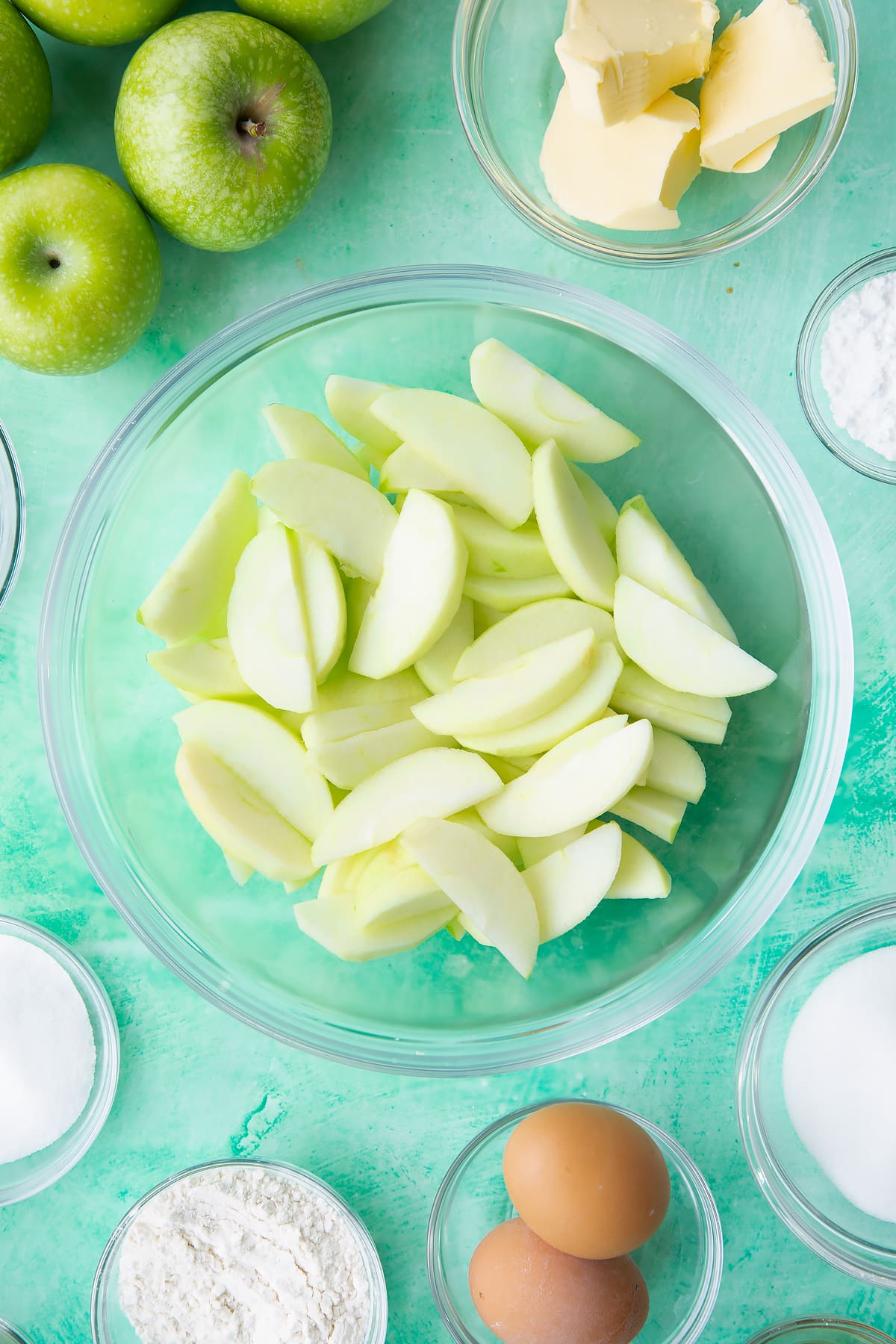 Sliced apples in a mixing bowl.