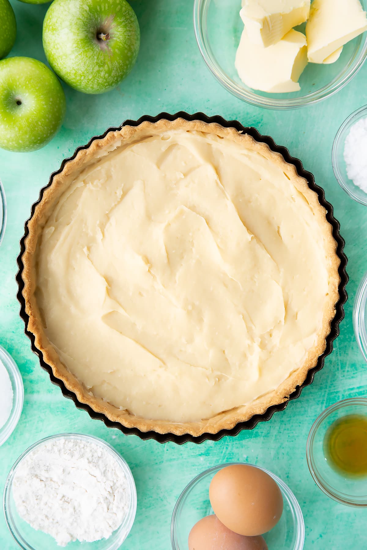 Overhead shot of the pastry tin once the custard has been spread across.