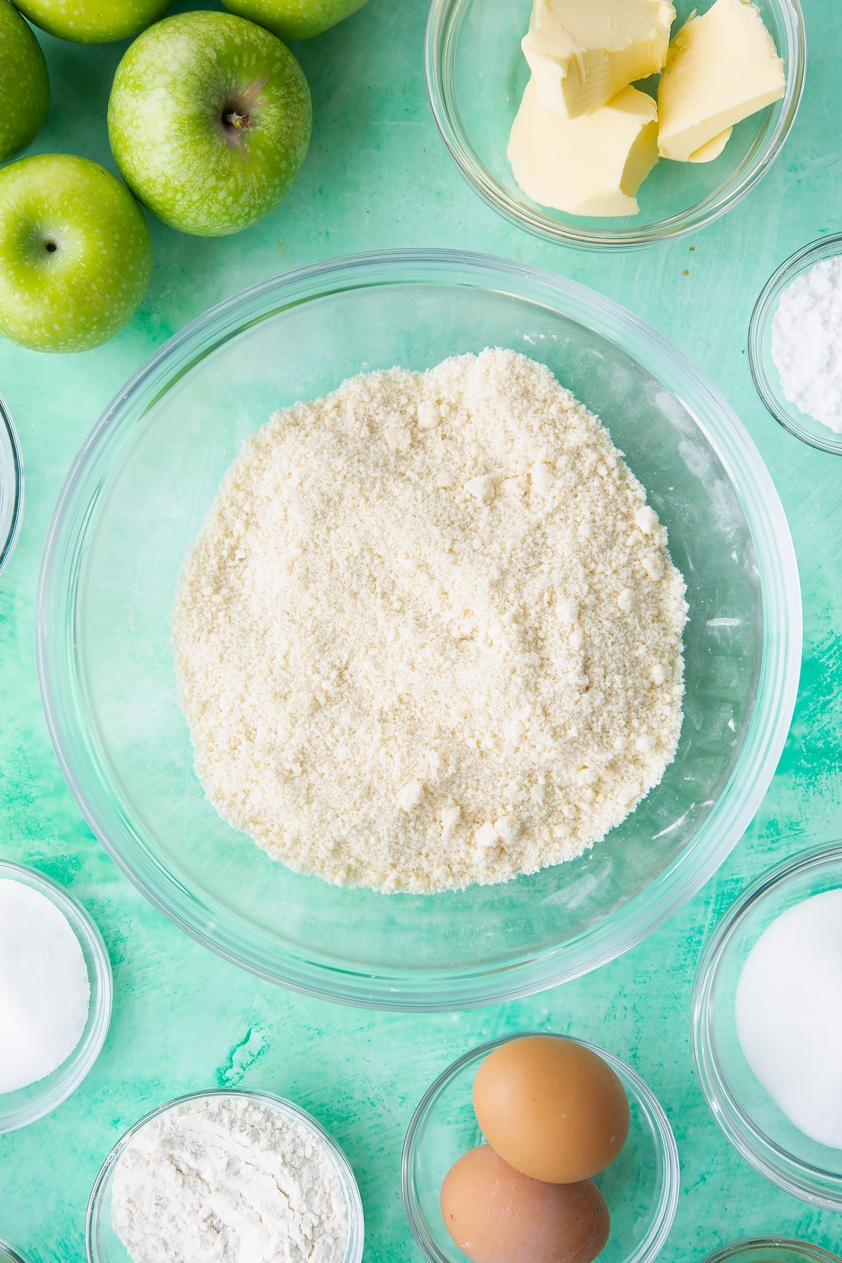 Rubbing the flour, icing sugar together in a mixing bowl.