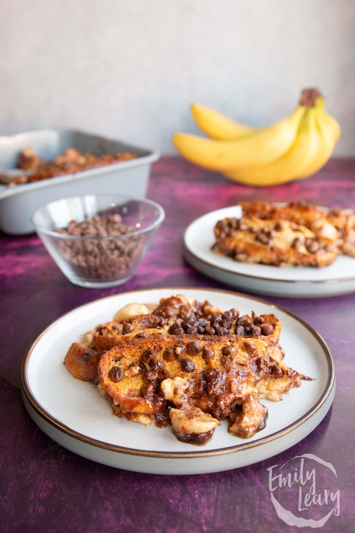 A finished serving of chocolate banana bread pudding on a decorative plate.