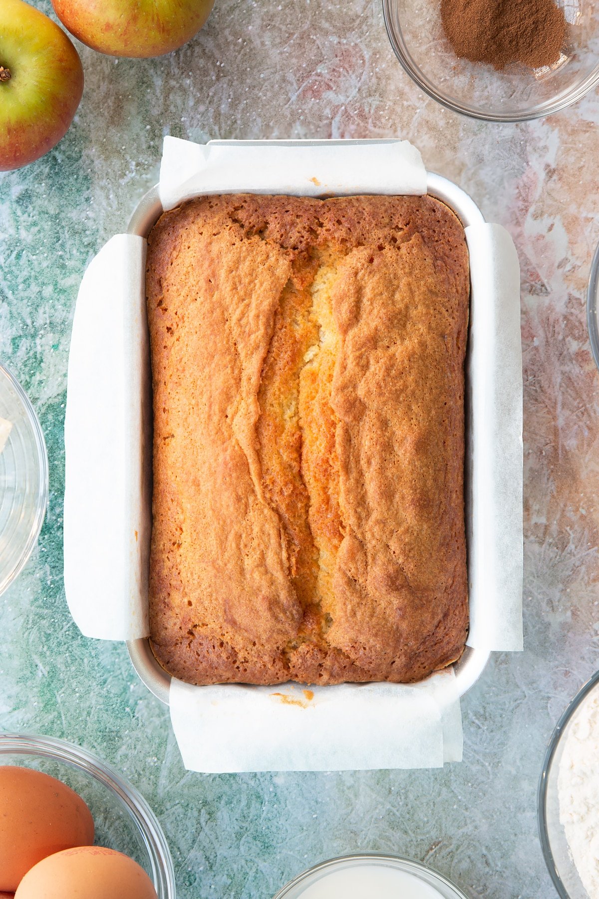 Spiced apple cake after being in the oven in a loaf tin.