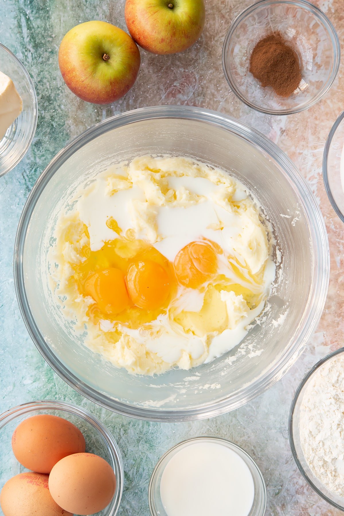 Adding eggs and milk to the cake batter.