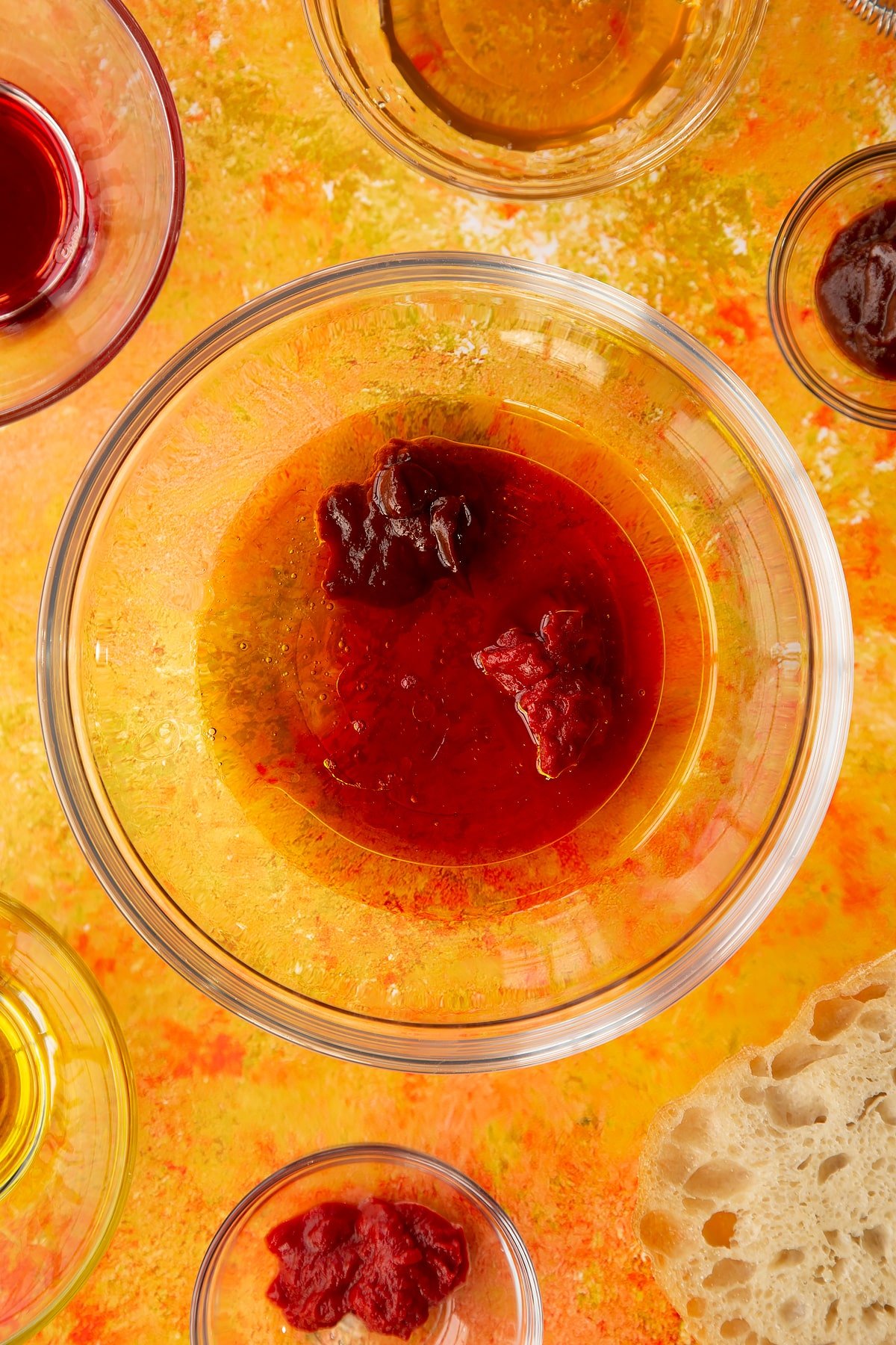 Overhead shot of the the honey, red wine vinegar, chipotle paste, tomato puree and olive oil in a bowl. 